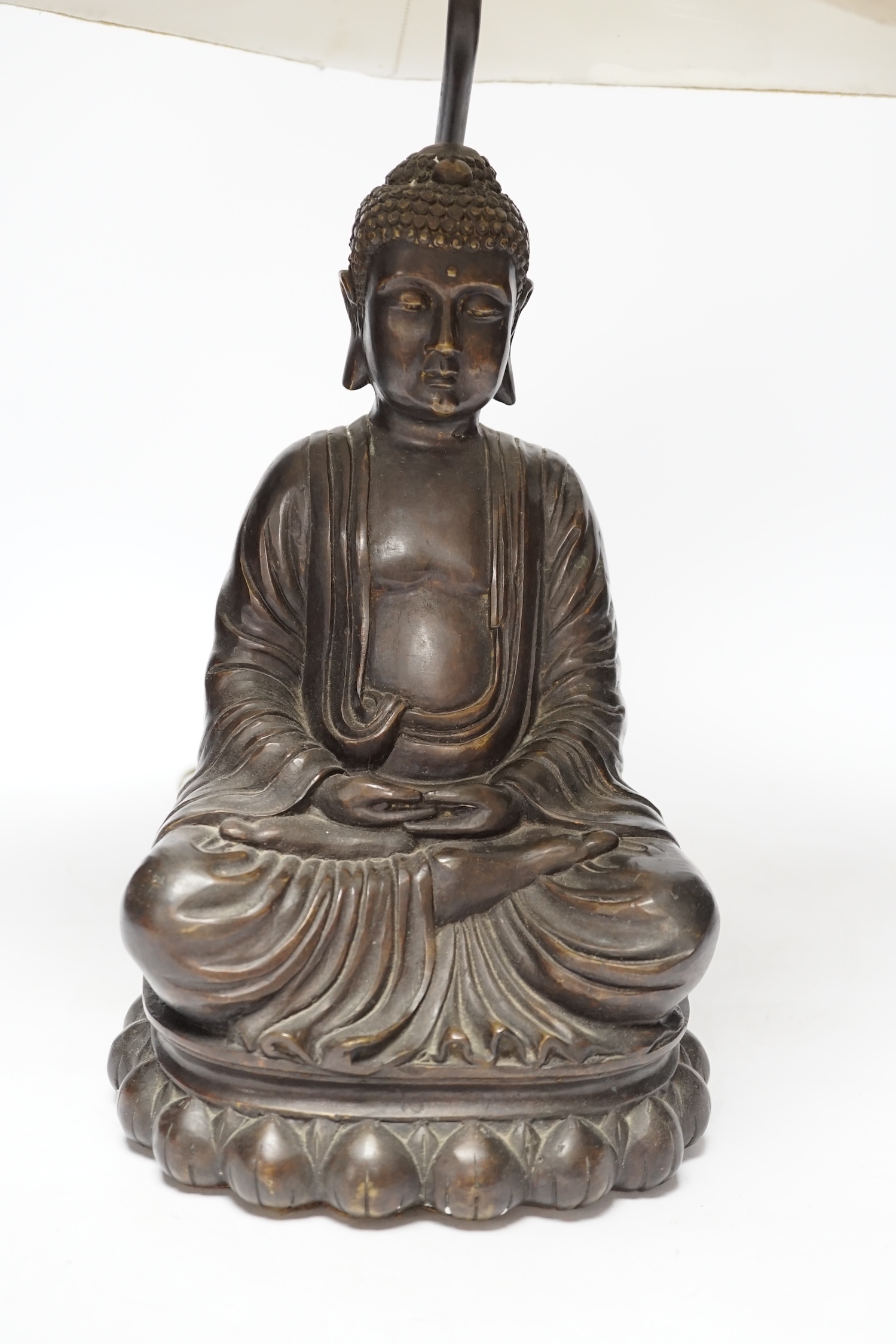 A bronzed Buddha table lamp, 57cm high including shade